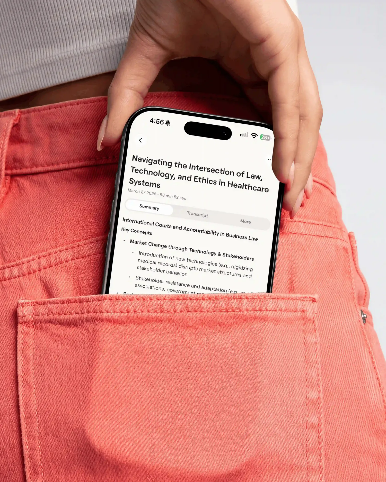 A student sliding a phone into their back pocket, showing a Notable lecture summary